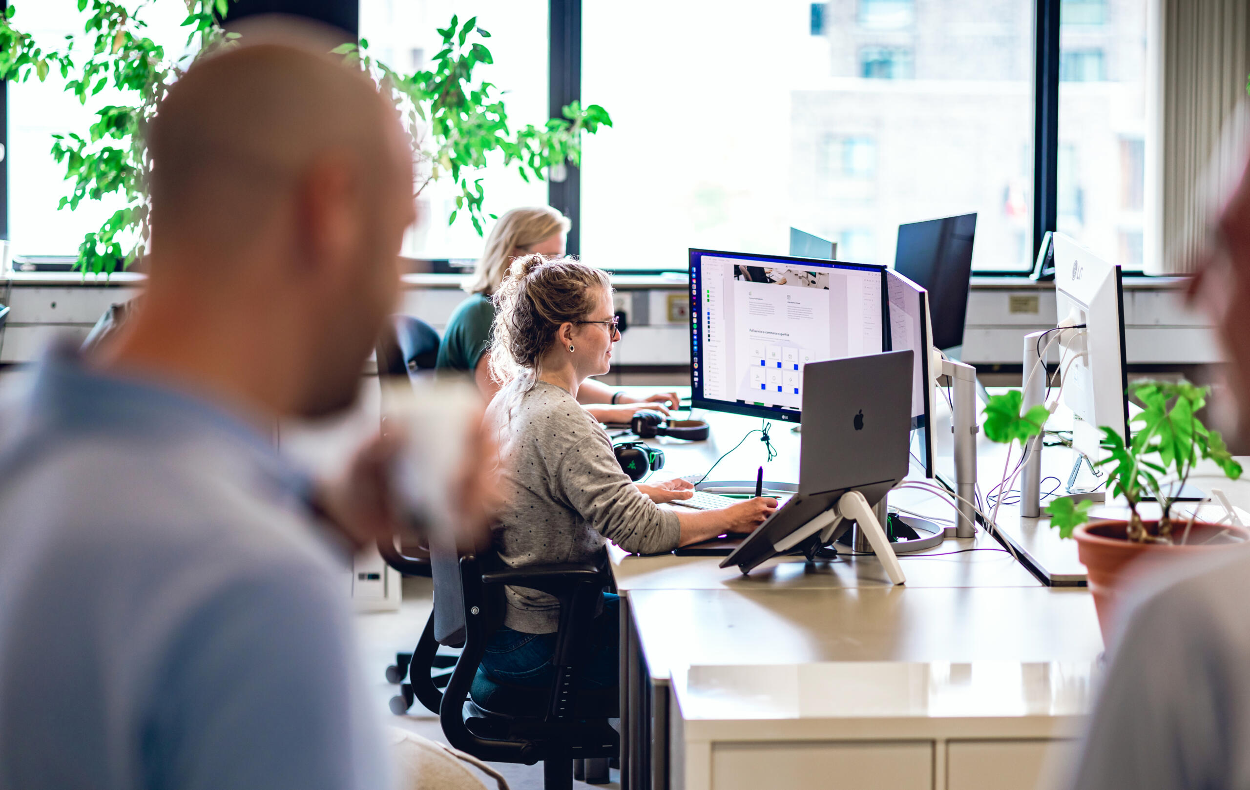 People working on a computer in the Madia office